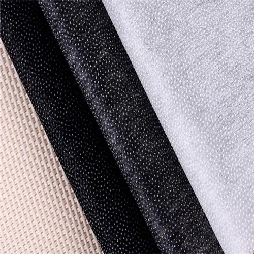 Assorted woven, non-woven and fusible interlining fabric samples in beige, black and white for garment manufacturing